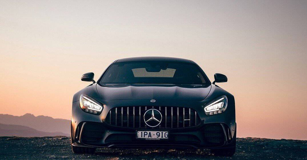 A Mercedes sedan at sunset